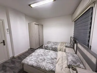 a bedroom with two beds and a window at 2BR Apartment in Tlaa Al Ali, Parking, AC, WIFI in Amman