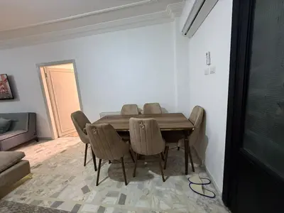 a dining room table and chairs in a room at 2BR Apartment in Tlaa Al Ali, Parking, AC, WIFI in Amman