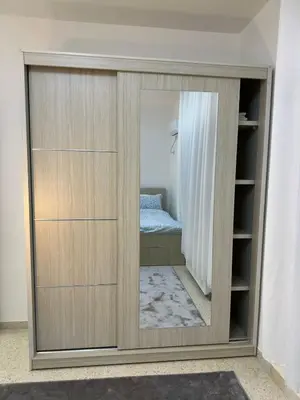 a wardrobe with a mirror in a room at Two-Bedroom Apartment in Swefieh in Amman