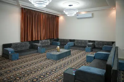 a meeting room with couches and a projection screen at الوجيه للشقق الفندقية in Amman