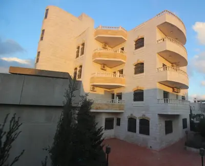 a building with balconies on the side of it at الوجيه للشقق الفندقية in Amman
