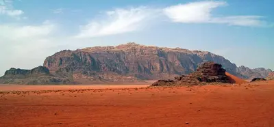 a mountain in the middle of a desert at Moon light in Disah