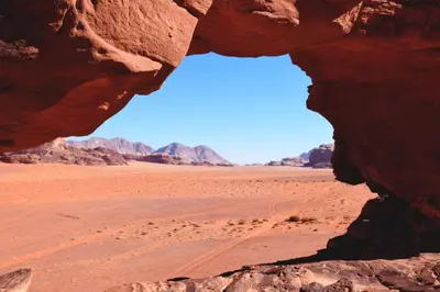 a window in a rock in the desert at Moon light in Disah
