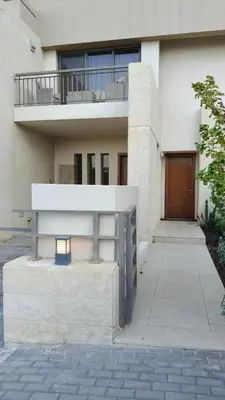 a large white building with a balcony on top of it at Al-Raha Luxury apartment in Aqaba