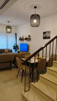a living room with a table and a couch at Al-Raha Luxury apartment in Aqaba