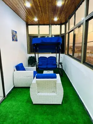 a room with two beds and green carpet at شقة واسعة وهادئة in Umm Juraysāt