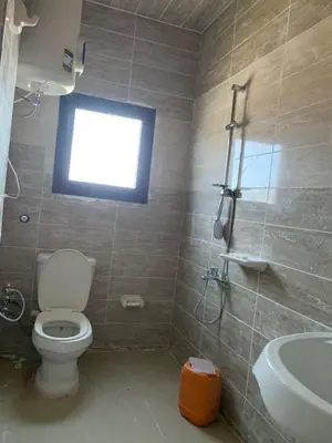a bathroom with a toilet and a sink and a window at Jorh BB in Amman