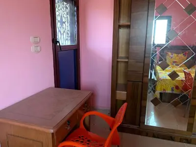 a small room with a desk and a red chair at Jorh BB in Amman