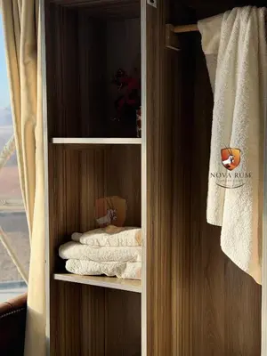 a towel rack with towels in a hotel room at Nova Rum Luxury Camp in Disah