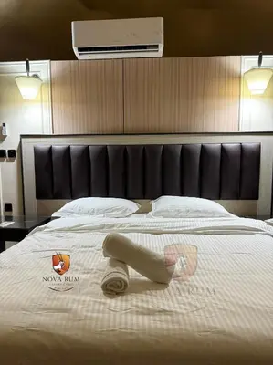 a bedroom with a large bed with a towel on it at Nova Rum Luxury Camp in Disah