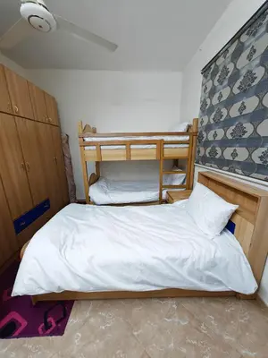 a bedroom with two bunk beds with white sheets at Luxury Apartments in Aqaba