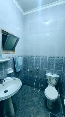 a bathroom with a toilet and a sink at Luxury Apartments in Aqaba