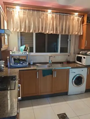 a kitchen with a sink and a washing machine at عمان in Amman