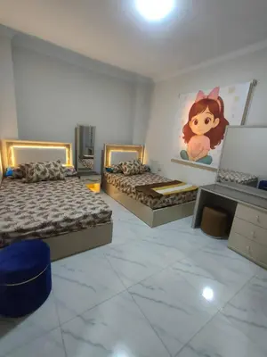 a bedroom with two beds and a monkey picture on the wall at Sama rjan in Irbid