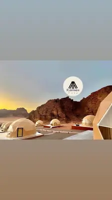a group of tents in a desert with a sign at Ramses luxury rum camp in Wadi Rum