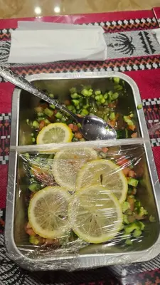 a tray of food with lemon slices and vegetables at Fahd Camp Wadi Rum in Wadi Rum