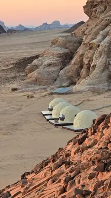 a row of tents lined up in the desert at Fahd Camp Wadi Rum in Wadi Rum