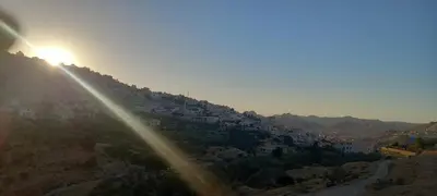 a view of a hill with the sun setting at Petra Breeze in Wadi Musa