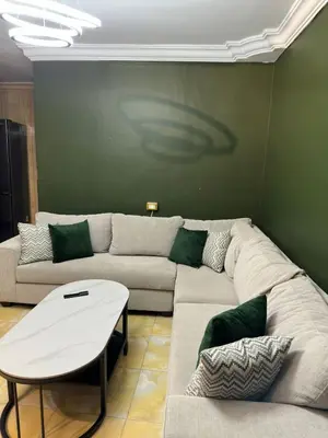 a living room with a couch and a table at Super deluxe apartment in Irbid