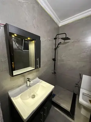 a bathroom with a sink and a shower at Super deluxe apartment in Irbid