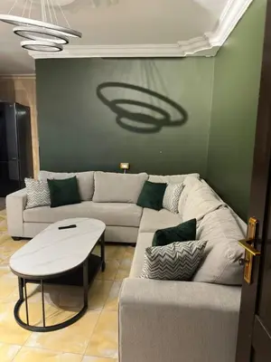 a living room with a couch and a table at Super deluxe apartment in Irbid