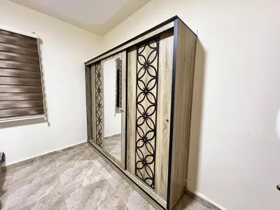 a wooden door in a room with a window at مزرعة وشاليه ادم