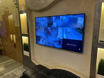 a flat screen tv hanging on a wall at No Stars in ‘Urjān al Gharbīyah