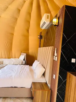 a room with a bed in a tent at Sand Desert Camp in Wadi Rum