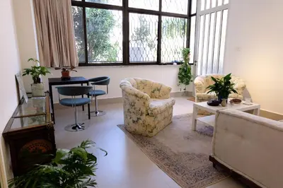 a living room with two chairs and a table at Sunny Studio in Amman in Amman