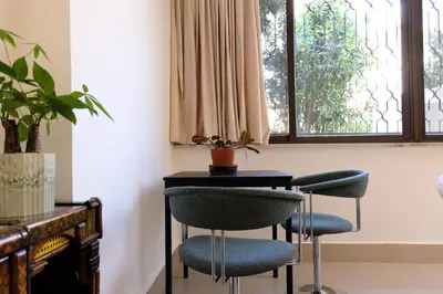 a room with two chairs and a table and a window at Sunny Studio in Amman in Amman
