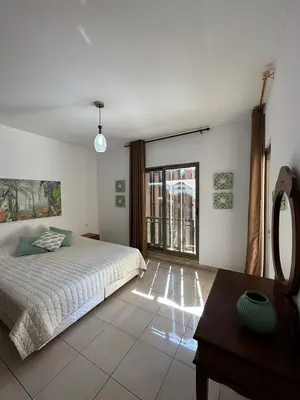 a bedroom with a bed and a large window at Two Bed rooms apartment in Talabay Aqaba Jordan in Aqaba
