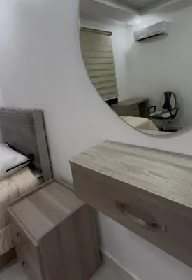 a bedroom with a mirror and a wooden desk at Luxury furnished apartment in Irbid