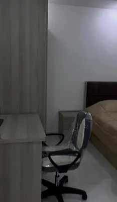 a desk and a chair in a room with a bed at Luxury furnished apartment in Irbid