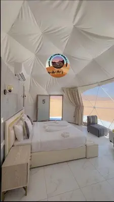 a bedroom with a large bed in a tent at MARS GATE lUXURY BUBBLE CAMP in Wadi Rum