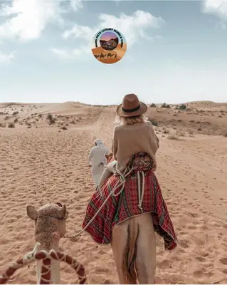 a woman is riding a camel in the desert at MARS GATE lUXURY BUBBLE CAMP in Wadi Rum