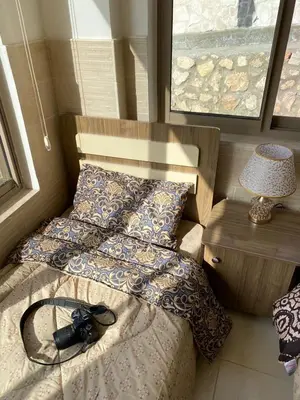 a camera on a bed in a room at panorama tal elroman chalet in Tal‘at ar Ruzz