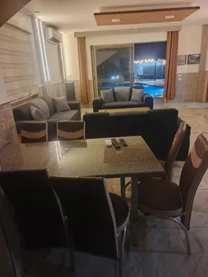 a living room with a table and a couch at panorama tal elroman chalet in Tal‘at ar Ruzz