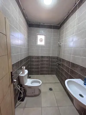 a bathroom with a toilet and a sink at Entire Home Near Deadsea & Baptism Site Pool, Garden, BBQ, Great Price in Shūnat Nimrīn