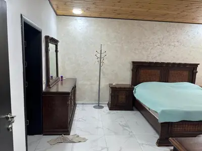 a bedroom with a bed and a sink and a mirror at New Rooftop 3 bedroom furnished apartment- Super deluxe in Amman