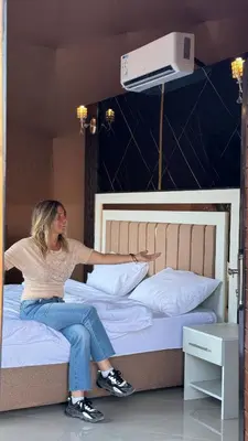 a woman sitting on top of a bed at Rum Rhal Luxury Camp in Aqaba
