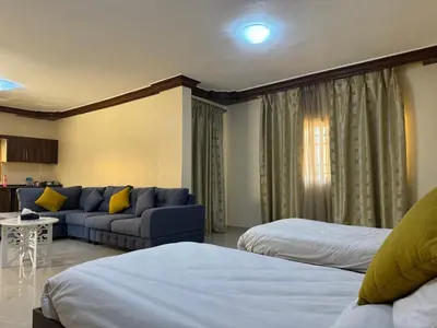 a living room with two beds and a couch at Casa de petra in Wadi Musa
