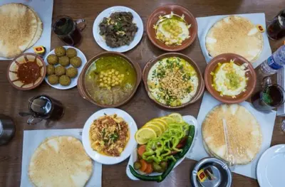 a table with many plates of food on it at Casa de petra in Wadi Musa