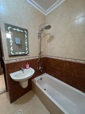 a bathroom with a tub and a sink and a bath tub at Casa de petra in Wadi Musa
