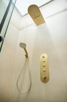 a shower with a shower head and a microphone at The Boulevard Residences in Amman