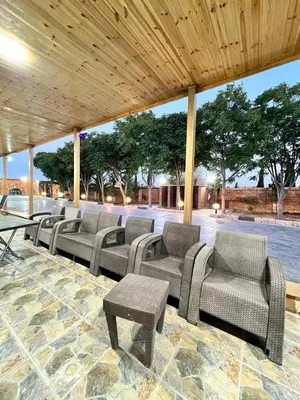 a group of chairs and tables under a pavilion at مزرعة وشاليه ادم
