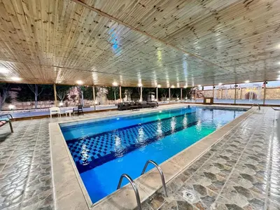 a large swimming pool with blue water at مزرعة وشاليه ادم