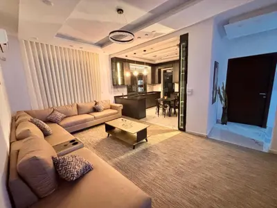 a living room with a couch and a table at Luxury comfortable apartment