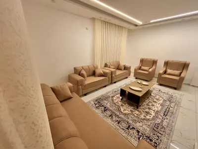 a living room with a couch and chairs and a table at Luxury comfortable apartment