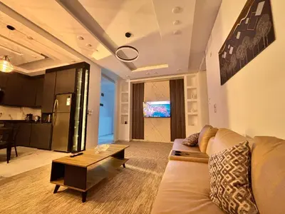 a living room with a couch and a table at Luxury comfortable apartment