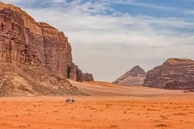 a group of people riding horses through the desert at Suleman Camp in Wadi Rum